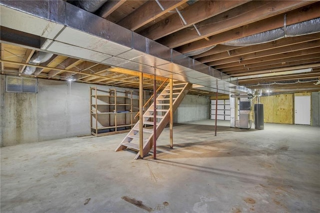 unfinished basement featuring water heater