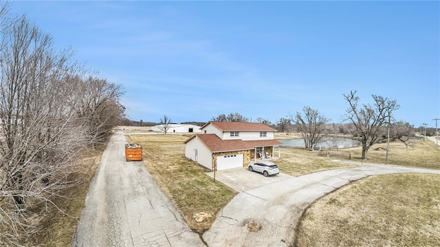 view of front facade with a front yard, driveway, and an attached garage