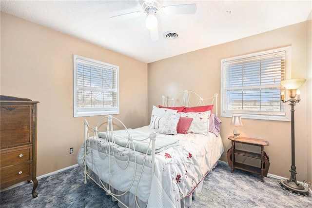 bedroom with a ceiling fan, carpet, visible vents, and baseboards