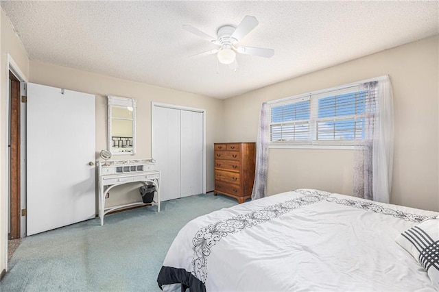 bedroom featuring carpet floors, a closet, and a textured ceiling