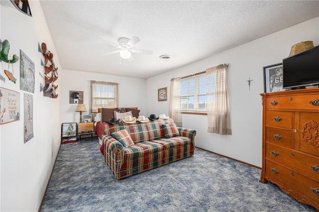 carpeted bedroom with visible vents, ceiling fan, a textured ceiling, and baseboards