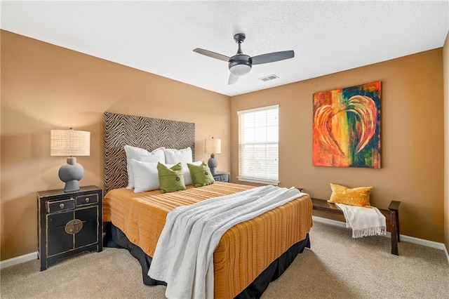 bedroom featuring visible vents, light carpet, and baseboards