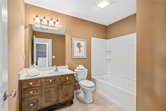 bathroom with washer / dryer, toilet, tile patterned floors, tub / shower combination, and vanity