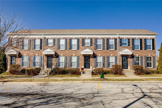 view of property with brick siding