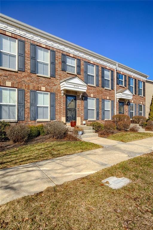 view of property featuring brick siding