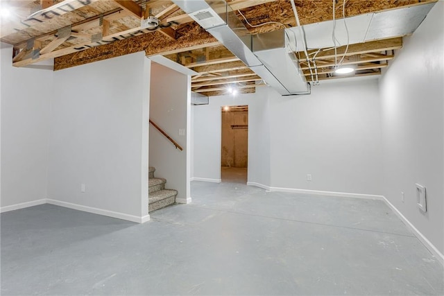 unfinished below grade area featuring stairs and baseboards