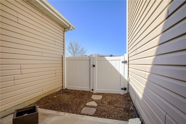 view of side of property featuring a gate and fence