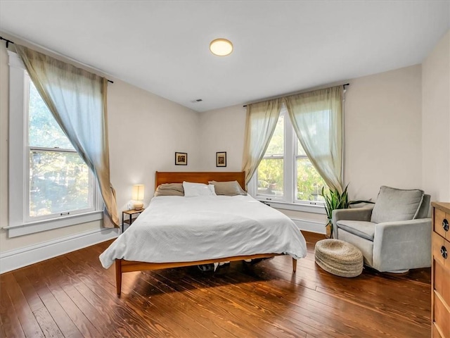 bedroom featuring hardwood / wood-style flooring and baseboards