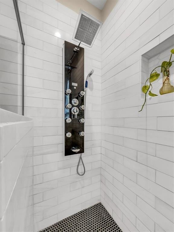 bathroom featuring visible vents and a tile shower