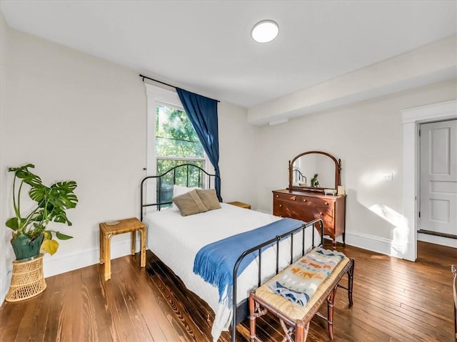 bedroom featuring baseboards and hardwood / wood-style floors