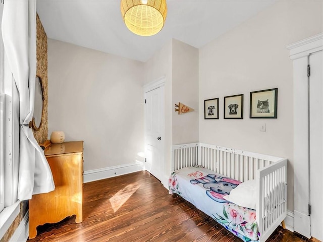 bedroom featuring baseboards and wood finished floors