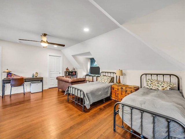 bedroom featuring a ceiling fan, vaulted ceiling, wood finished floors, and recessed lighting