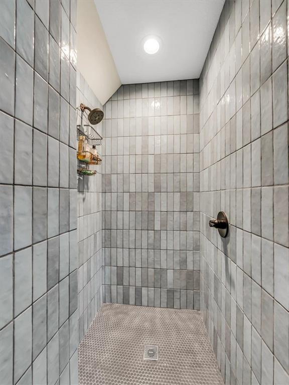 bathroom with a tile shower