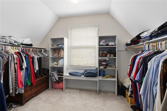 walk in closet with carpet flooring and lofted ceiling