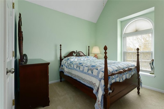 carpeted bedroom with baseboards and lofted ceiling