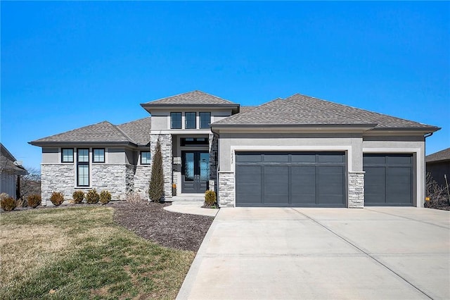 prairie-style house with a front yard, french doors, a garage, and stucco siding