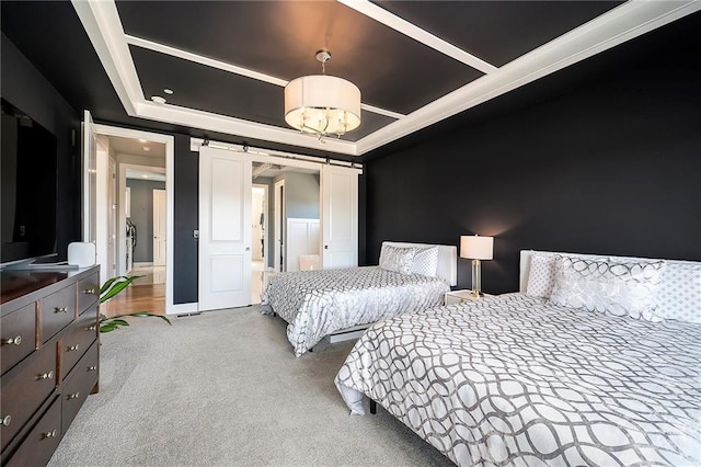 carpeted bedroom featuring a notable chandelier, a tray ceiling, and a barn door