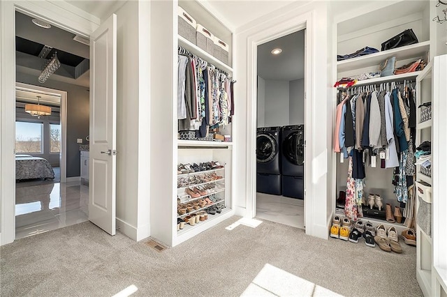 spacious closet featuring carpet flooring and washer and clothes dryer