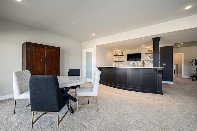 dining room featuring light carpet, recessed lighting, and baseboards