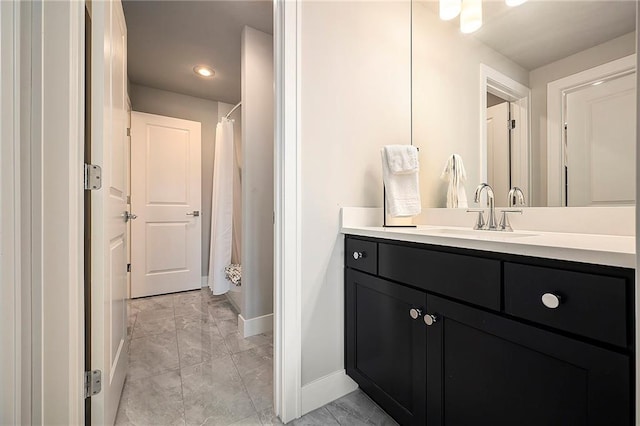 bathroom with baseboards, a shower with curtain, marble finish floor, and vanity