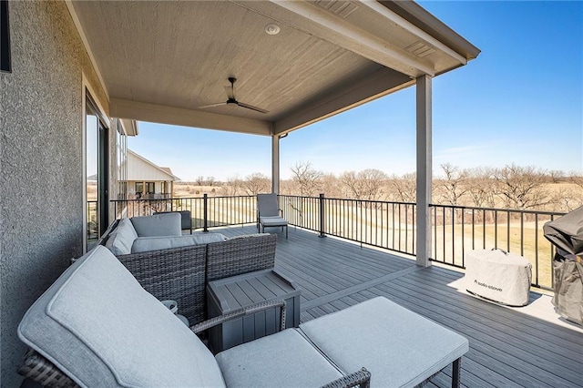 wooden terrace featuring an outdoor living space and ceiling fan