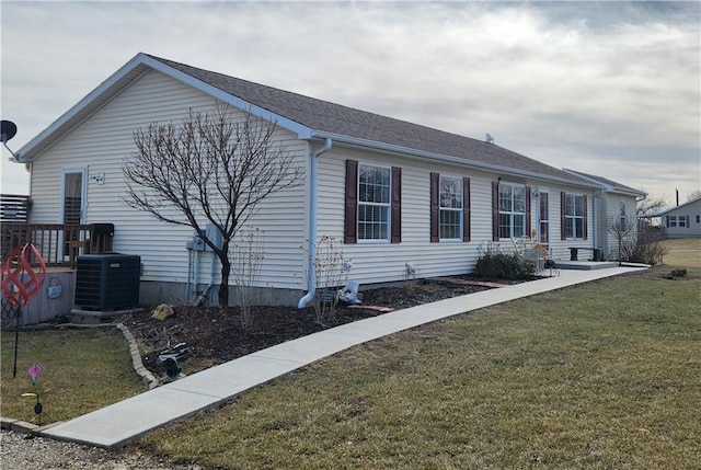 exterior space featuring a yard and central AC unit