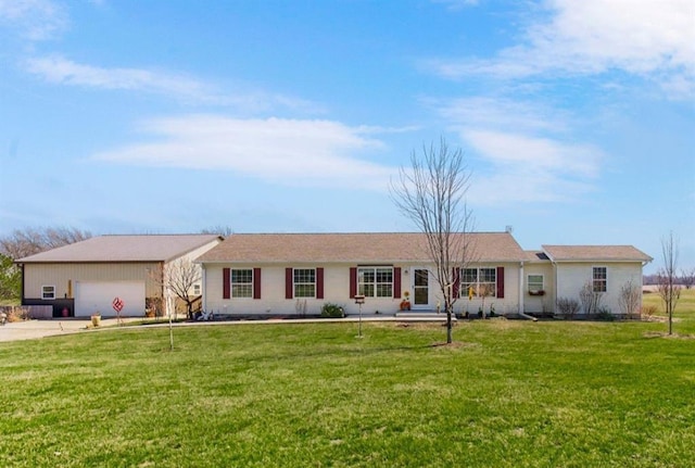 ranch-style home with driveway, a front yard, and a garage