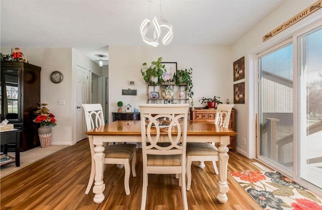 dining room with baseboards and wood finished floors