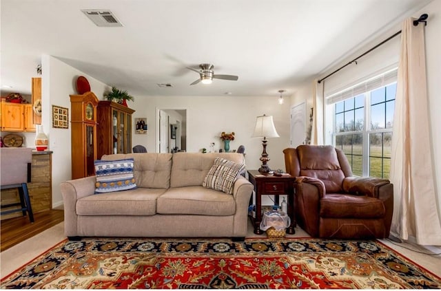 living room with visible vents and a ceiling fan