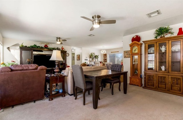 dining area with visible vents, light carpet, and a ceiling fan