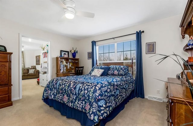 carpeted bedroom featuring visible vents, a ceiling fan, and baseboards