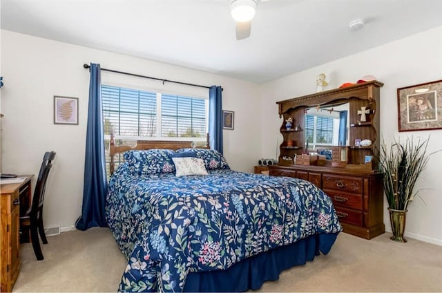 carpeted bedroom featuring baseboards and ceiling fan