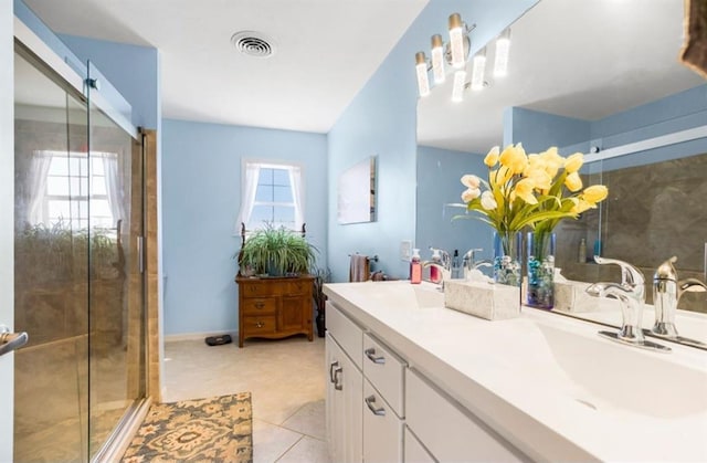 bathroom with tile patterned floors, visible vents, vanity, and a shower stall