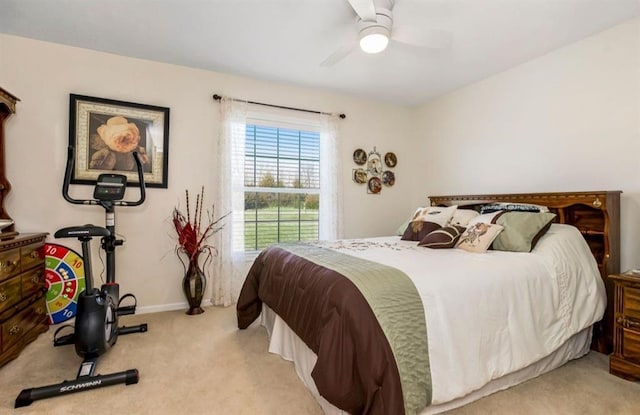 carpeted bedroom featuring baseboards and ceiling fan