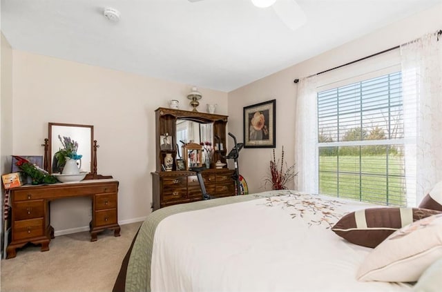 bedroom featuring light colored carpet and baseboards