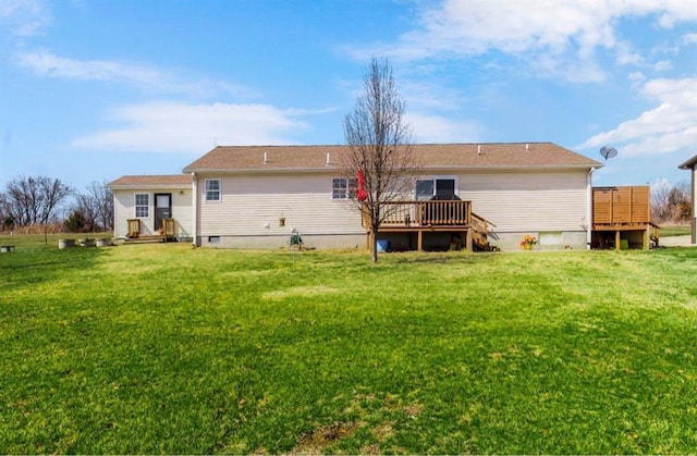 back of house featuring a wooden deck and a yard