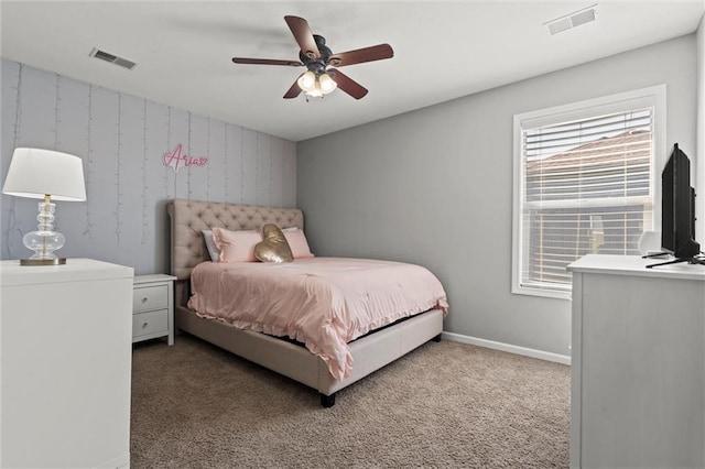 carpeted bedroom featuring visible vents, ceiling fan, and baseboards