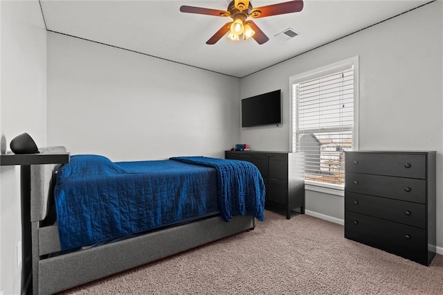 bedroom featuring light carpet, ceiling fan, visible vents, and baseboards