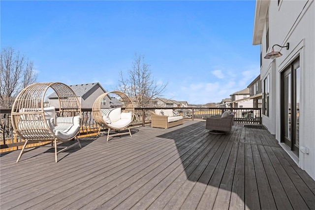 wooden deck featuring a residential view and an outdoor living space