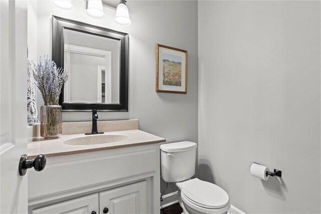 630 N Laurel St, Gardner, KS 66030 - half bath with vanity, baseboards, and toilet