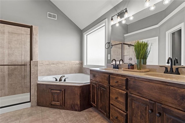 bathroom with visible vents, a shower stall, a sink, and lofted ceiling