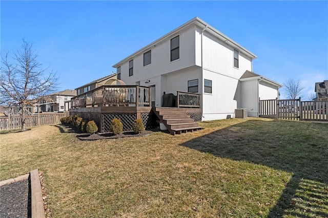 rear view of property with a fenced backyard, a wooden deck, a lawn, and central AC unit