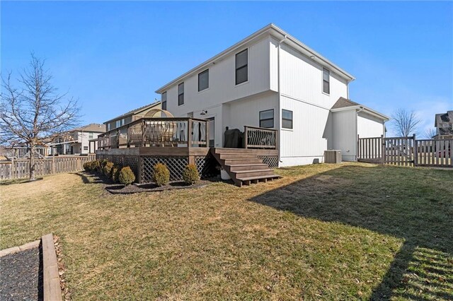 630 N Laurel St, Gardner, KS 66030 - rear view of property with a fenced backyard, a wooden deck, a lawn, and central AC unit
