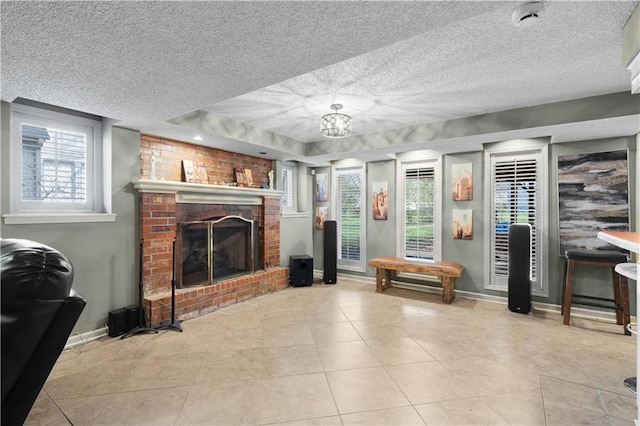 132 The Woodlands Dr, Gladstone, MO 64119 - living room featuring tile patterned flooring, a brick fireplace, baseboards, and a textured ceiling