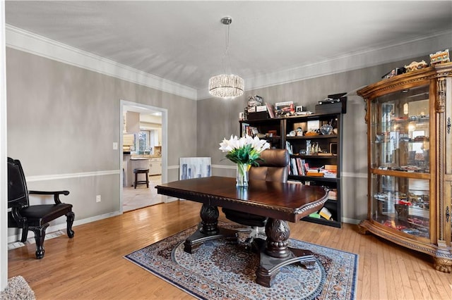 132 The Woodlands Dr, Gladstone, MO 64119 - office space with hardwood / wood-style floors, baseboards, ornamental molding, and an inviting chandelier
