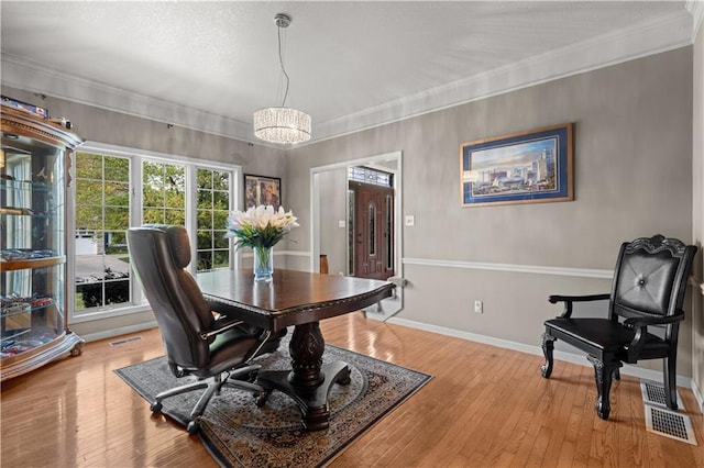 132 The Woodlands Dr, Gladstone, MO 64119 - dining room with light wood finished floors, baseboards, an inviting chandelier, and visible vents