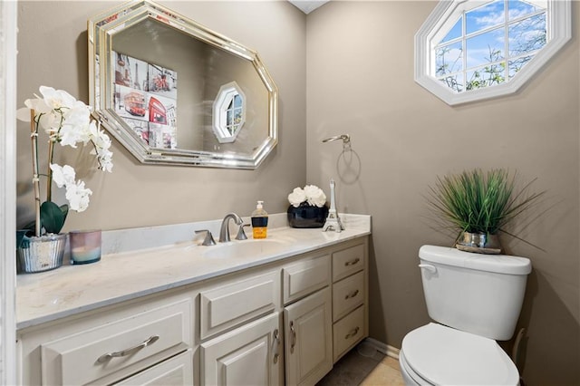 132 The Woodlands Dr, Gladstone, MO 64119 - half bathroom featuring toilet, vanity, and tile patterned floors