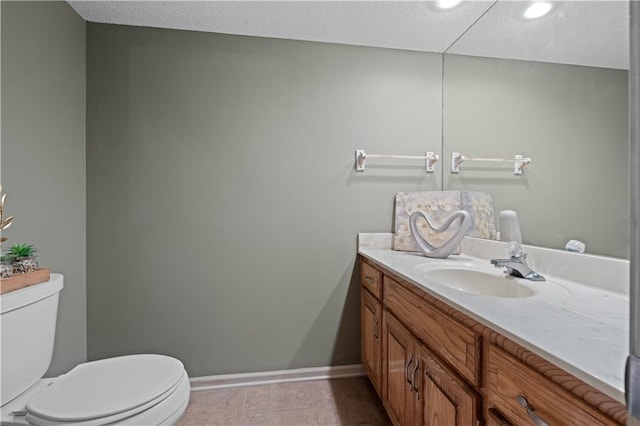 132 The Woodlands Dr, Gladstone, MO 64119 - half bath featuring baseboards, toilet, vanity, and tile patterned floors