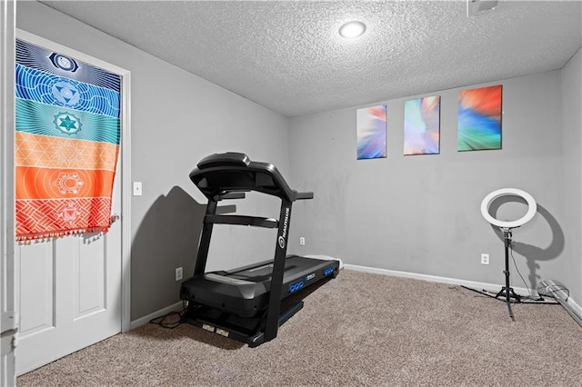 132 The Woodlands Dr, Gladstone, MO 64119 - workout room featuring baseboards, a textured ceiling, and carpet