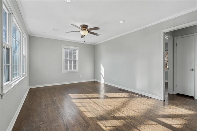 unfurnished room featuring dark wood-style flooring, a ceiling fan, baseboards, and ornamental molding